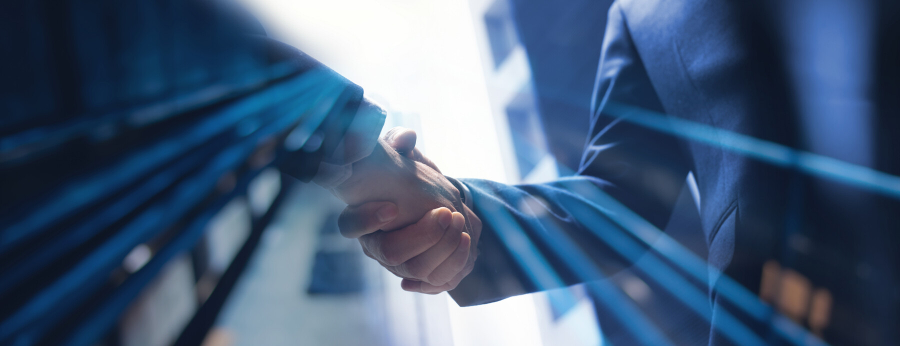Two hands are shown clasped in agreement.