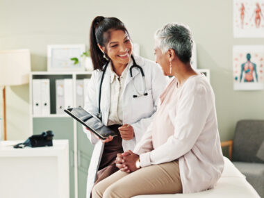 An image of a female doctor speaking with a patient.