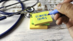 A hand holds a marker next to a Post-It with 
