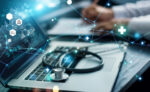 A stethoscope is seen lying on a laptop's keyboard.