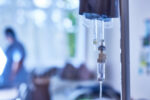 A intravenous infusion treatment is seen close-up.