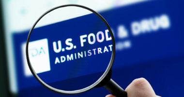A photo shows a magnifying glass focusing on the FDA logo