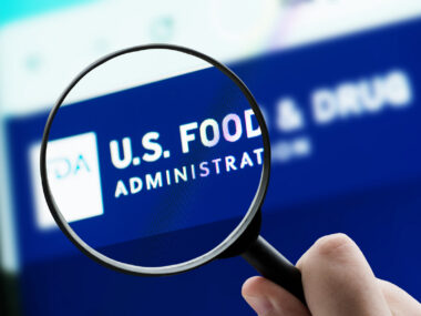 A photo shows a magnifying glass focusing on the FDA logo