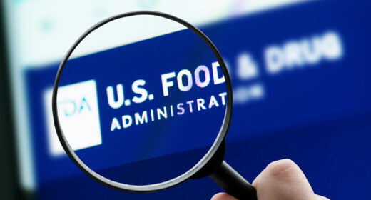 A photo shows a magnifying glass focusing on the FDA logo